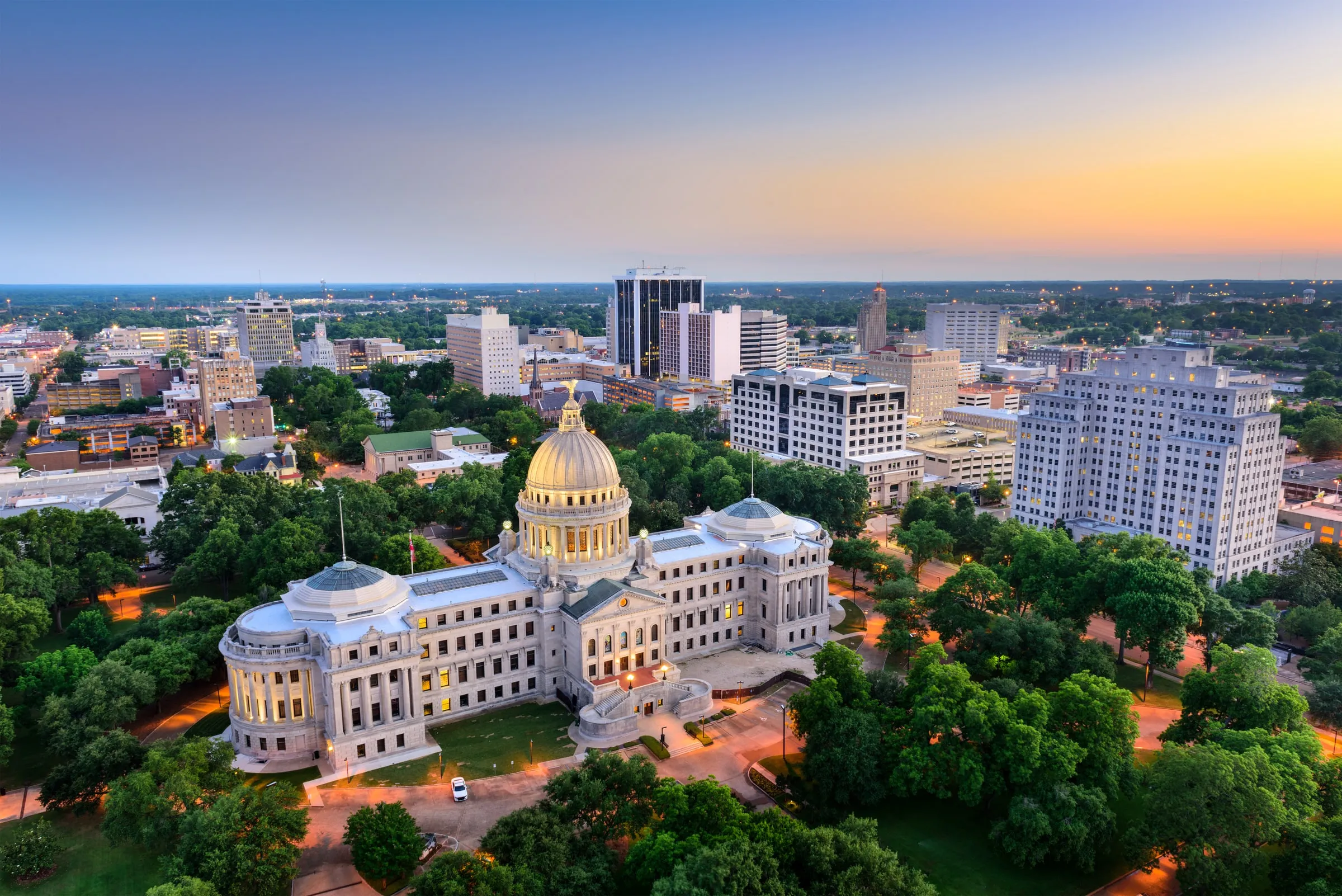 Downtown Jackson, Mississippi at dusk, with the State Capitol dome in the foreground